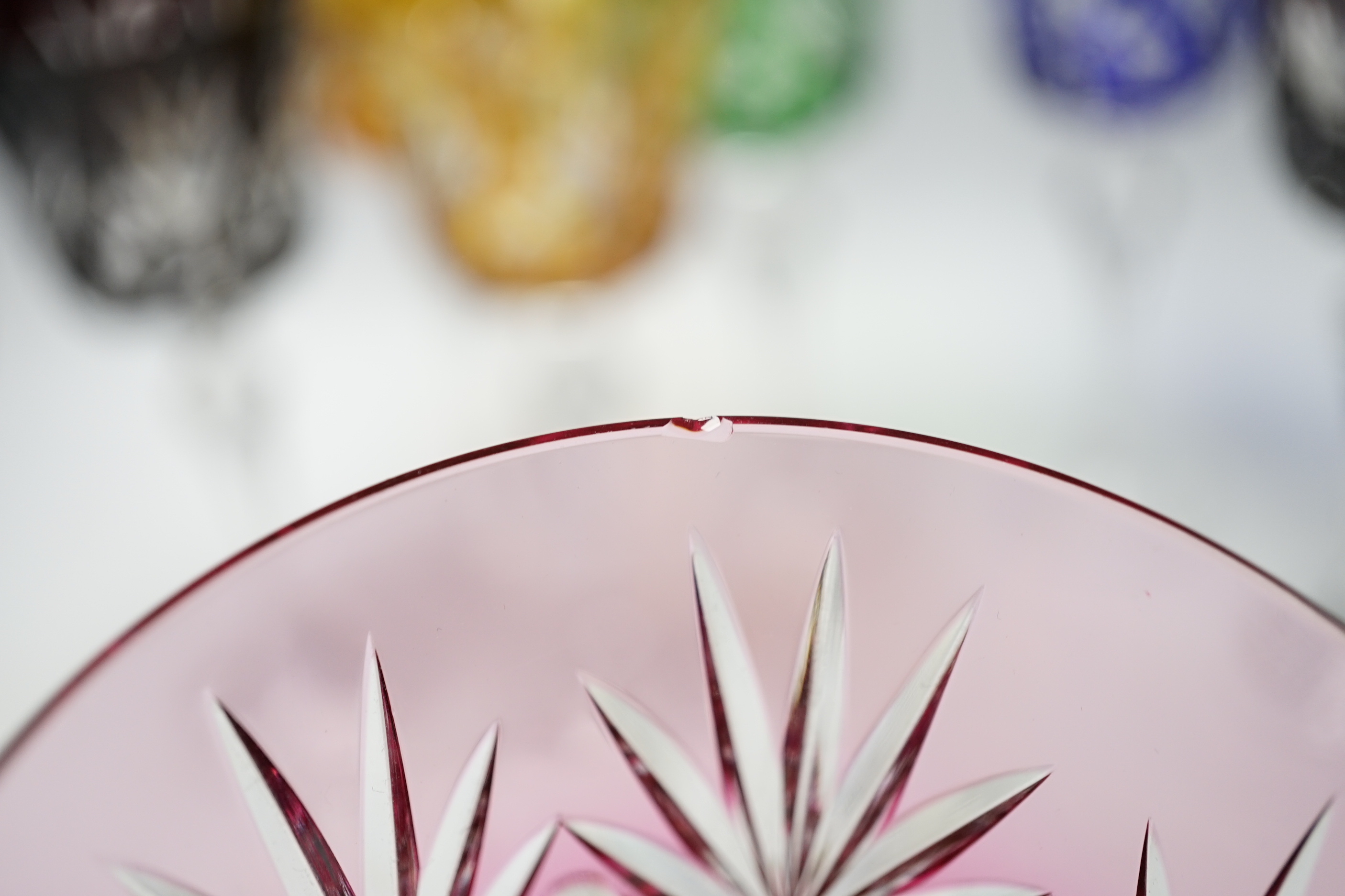 Eight Bohemian cut glass and coloured overlay wine glasses on cut tapering stems